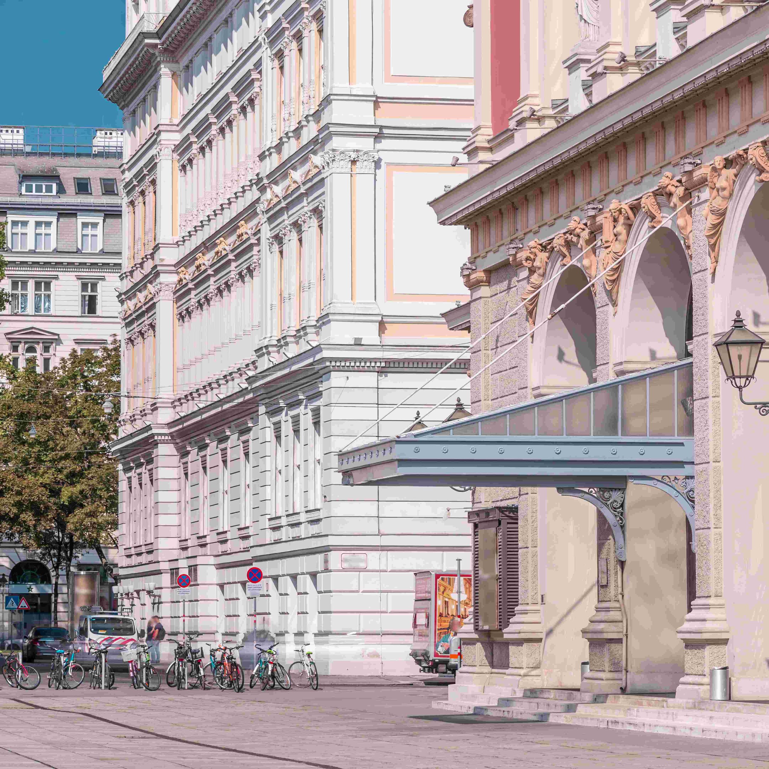 The Wiener Musikverein timelapse (Viennese Music Association) is a famous Vienna concert hall. It was built in 1870. Street with green trees on a background